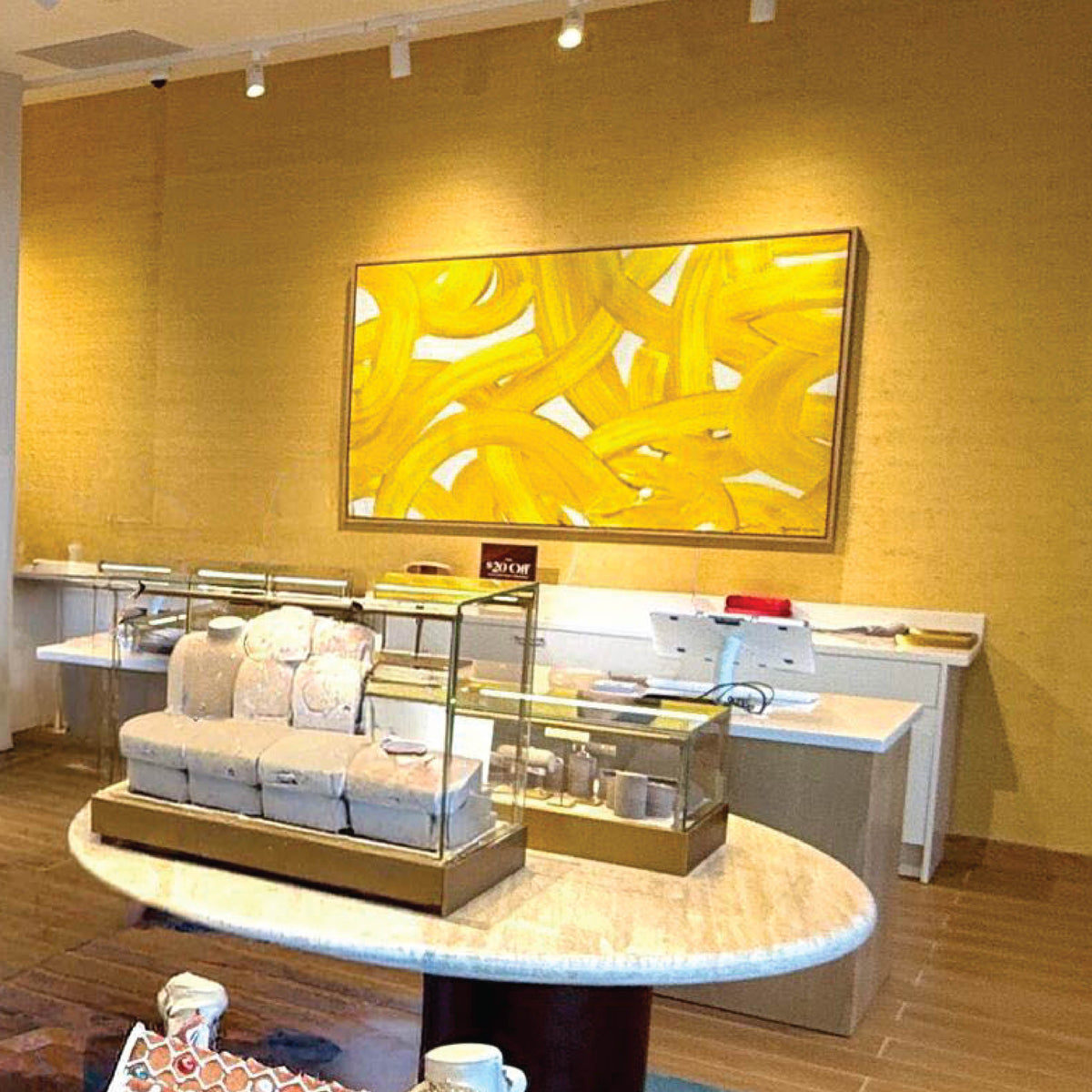 Illuminated display case with artwork above