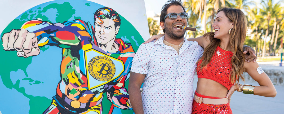Couple in front of a painted globe and superhero mural