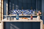 Navy blue kitchen island styled scene with blue glass pitcher, mugs and vases
