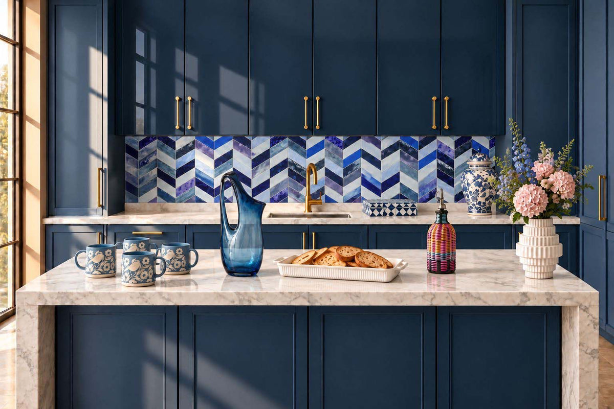 Navy blue kitchen island styled scene with blue glass pitcher, mugs and vases
