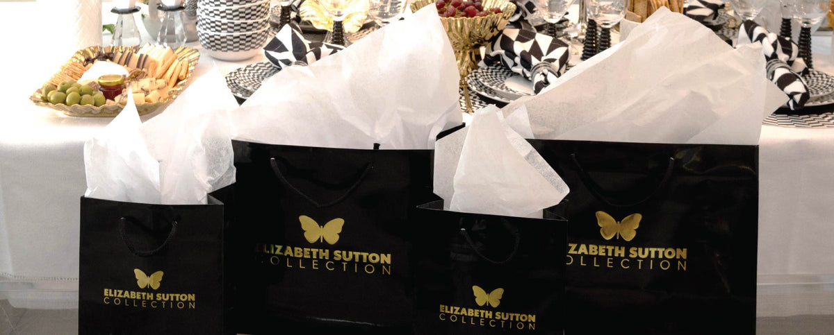 Elizabeth Sutton Collection gift bags with tissue paper on a set table