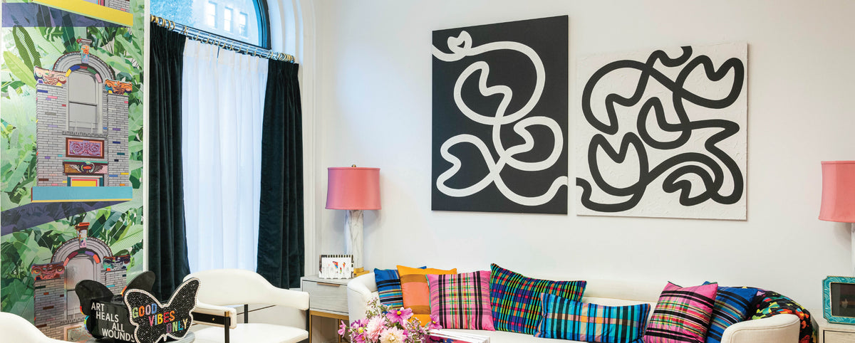 Colorful sitting room with black and white squiggle paintings