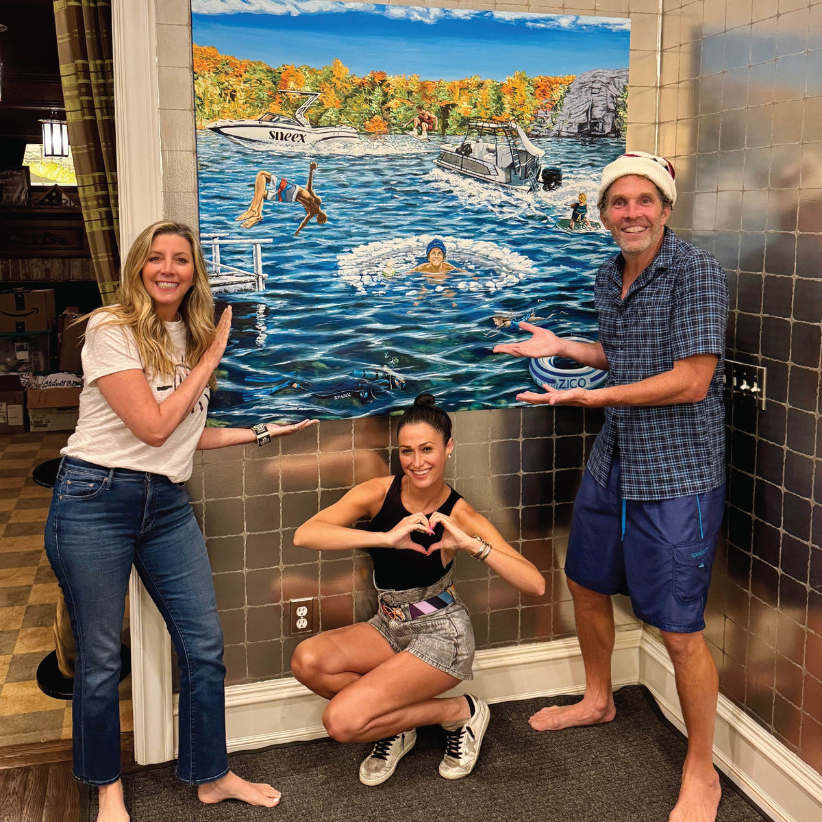 Guests in front of an Elizabeth Sutton mural