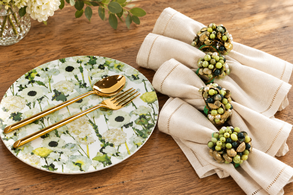 Cream Floral Garden plate with beaded napkin rings and cream linen on natural wood
