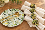 Cream Floral Garden plate with beaded napkin rings and cream linen on natural wood
