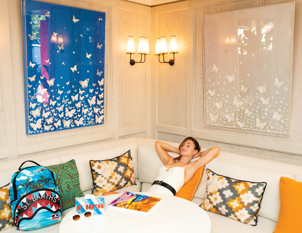 Eden Rock St. Barths lounge styled with Elizabeth Sutton clutches and Sprayground backpacks