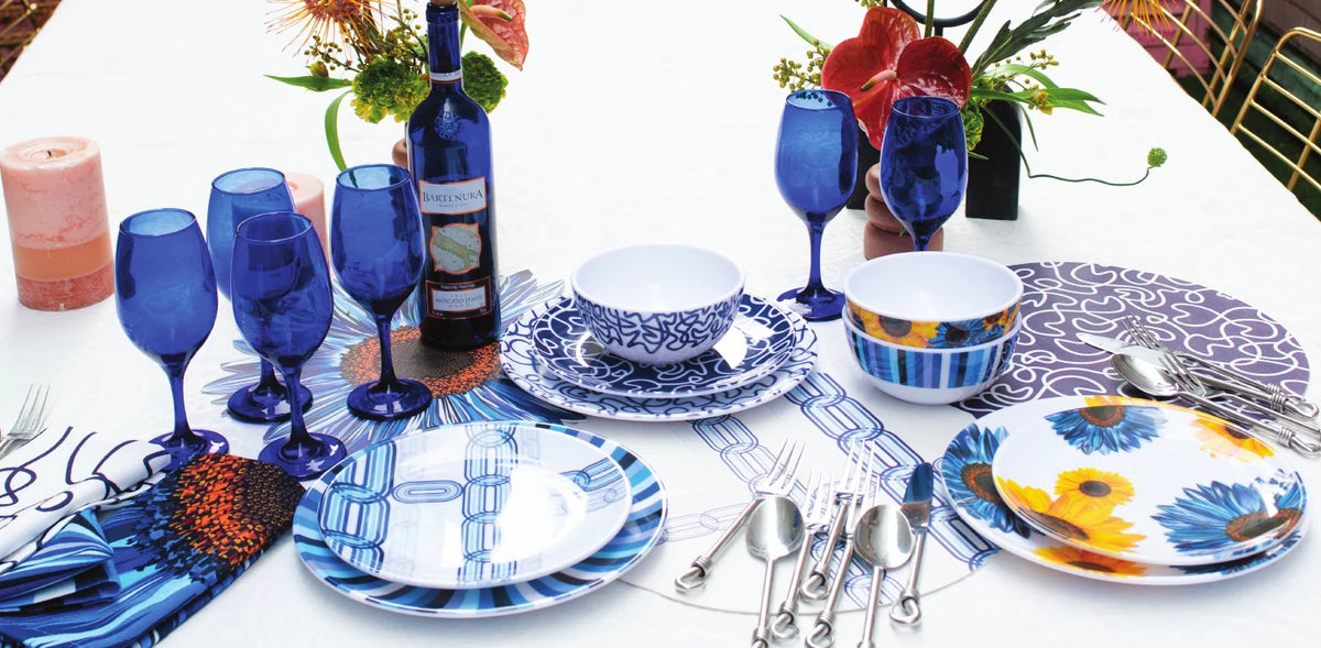 Table set with blue and white melamine dinnerware and glassware
