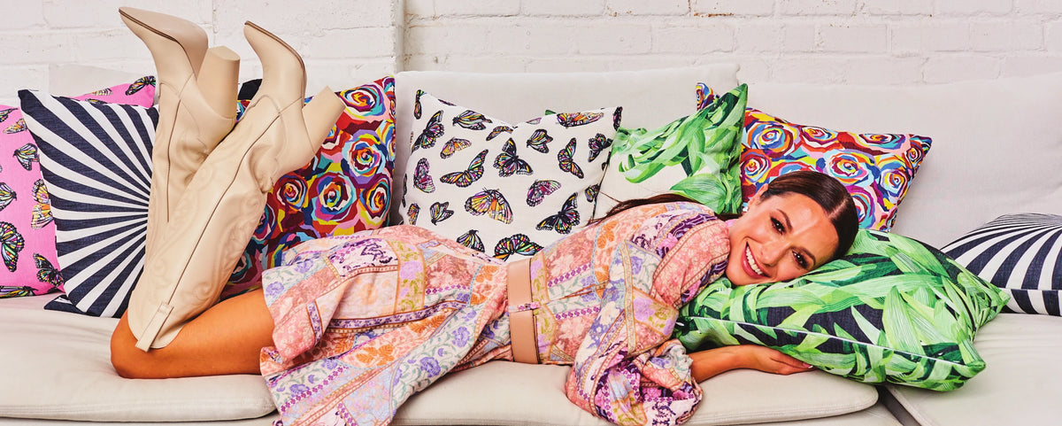 Elizabeth Sutton reclining among printed pillows