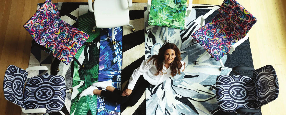 Elizabeth Sutton surrounded by printed textiles