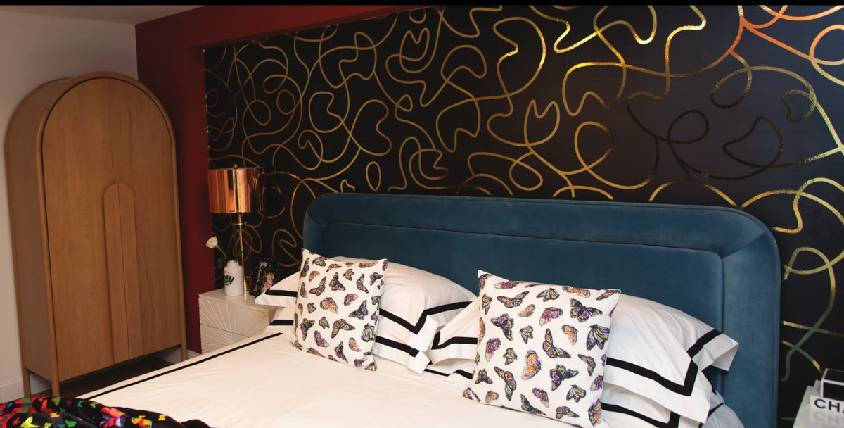 Bedroom with gold line pattern wallpaper