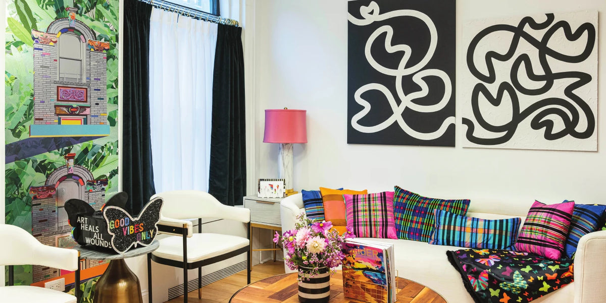 Living room with botanical wallpaper and black and white art