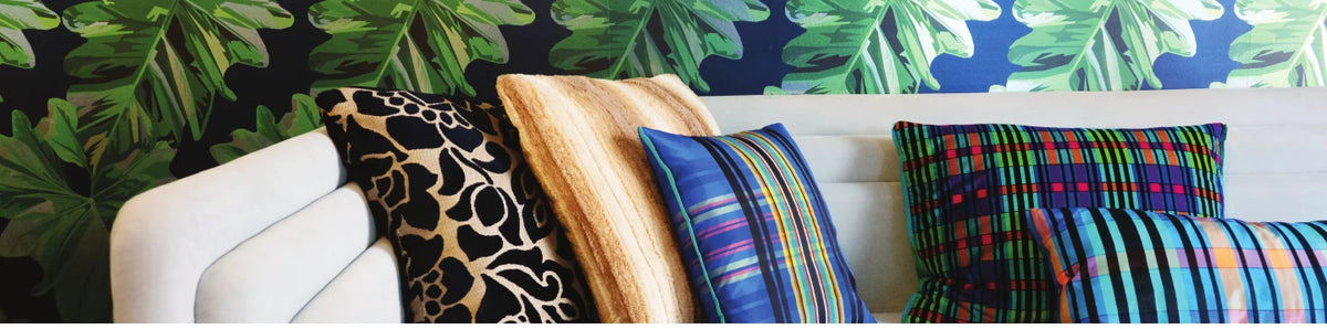 Living room styled with Elizabeth Sutton print pillows and throws