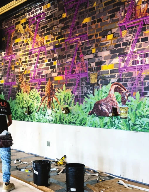Mural installation in progress at Champagne Problems